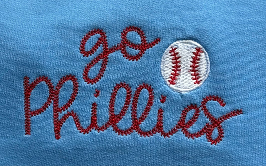 Embroidered text 'go Phillies' with a baseball on a blue background