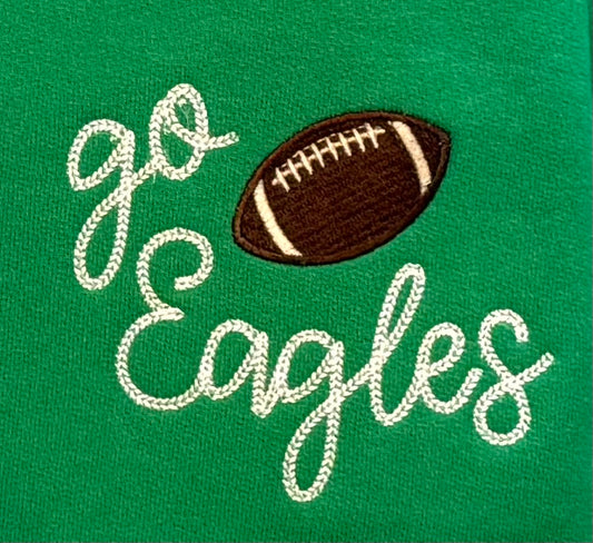 Embroidered football and 'go Eagles' text on a green fabric