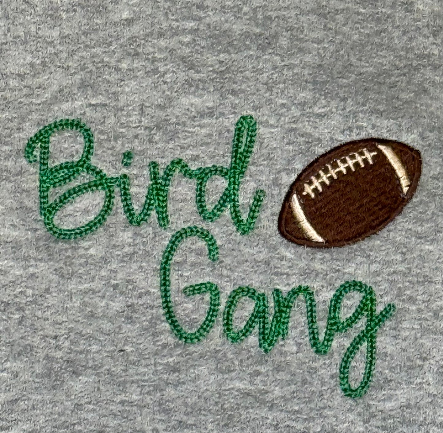 Gray fabric with 'Bird Gang' embroidered text and a football graphic