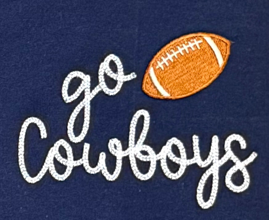 Embroidered text 'go Cowboys' with a football on a navy background